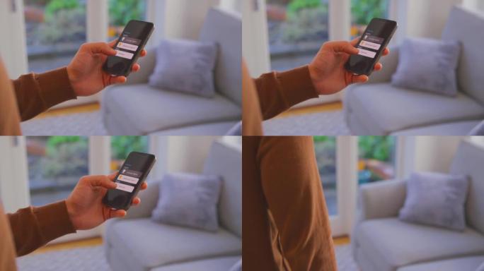 男人在家中的特写镜头看着智能手机上的应用程序来控制灯光-慢动作拍摄
