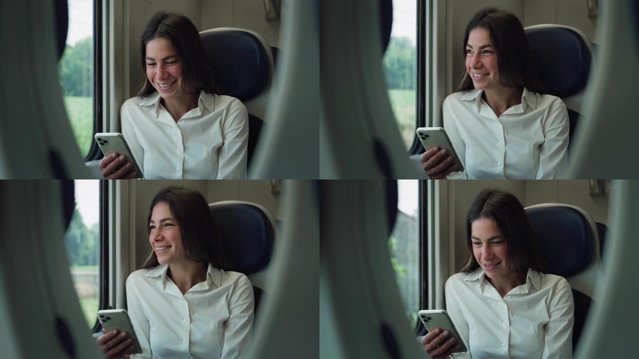 快乐微笑的女性在乘火车旅行时使用智能手机。女人拿着手机，发布社交媒体，网上购物，发短信，玩手机游戏，