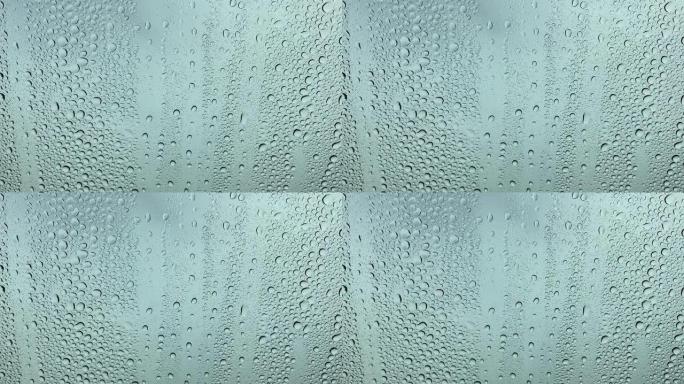 玻璃上的雨特写透明水滴落在