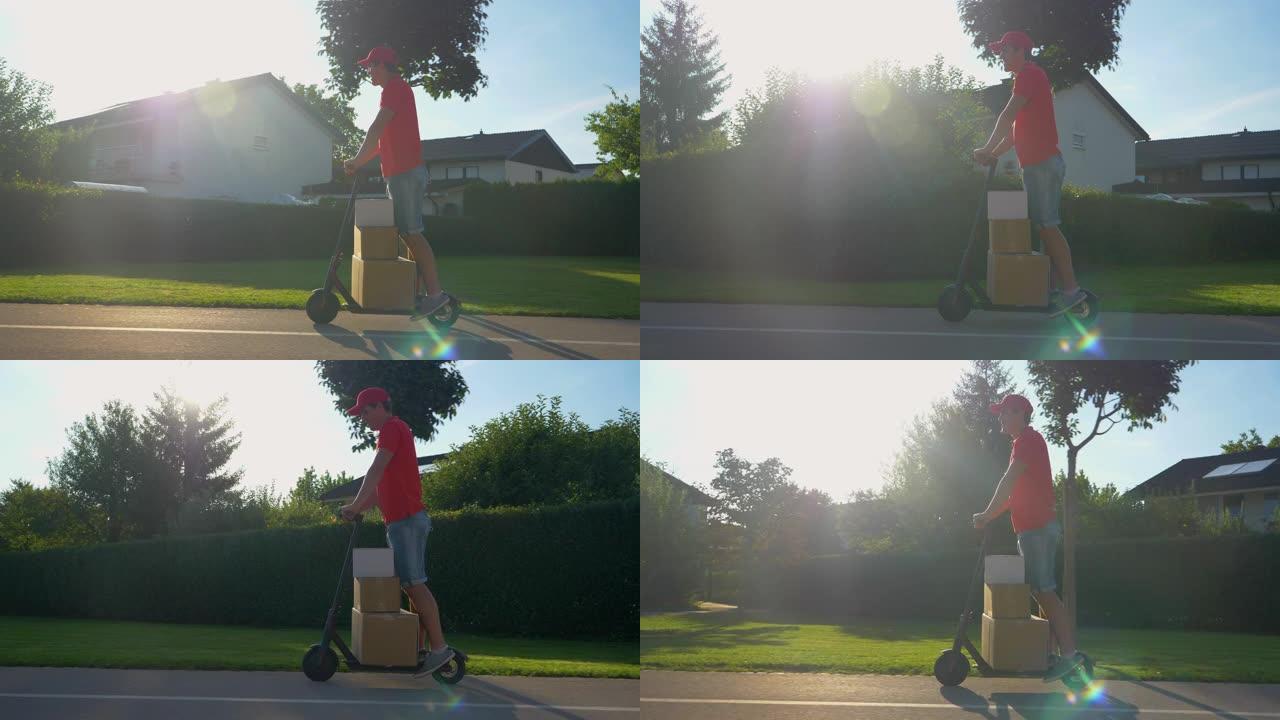 镜头耀斑: 年轻的快递员在阳光明媚的日子里用他的电动踏板车运送包裹。