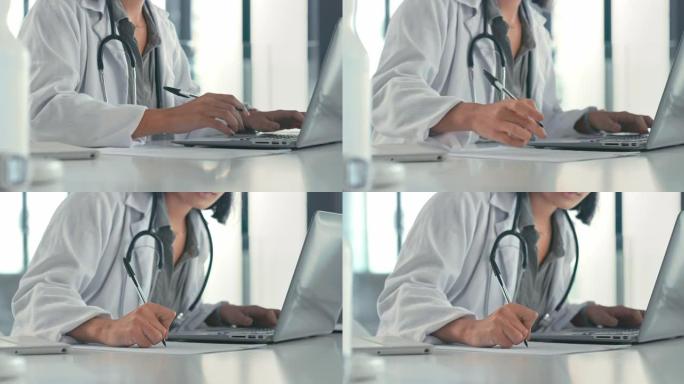 4k视频片段，一个无法识别的医生在工作时使用笔记本电脑做笔记