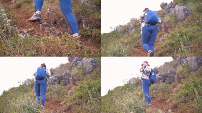 女人在岩石上徒步旅行到山顶