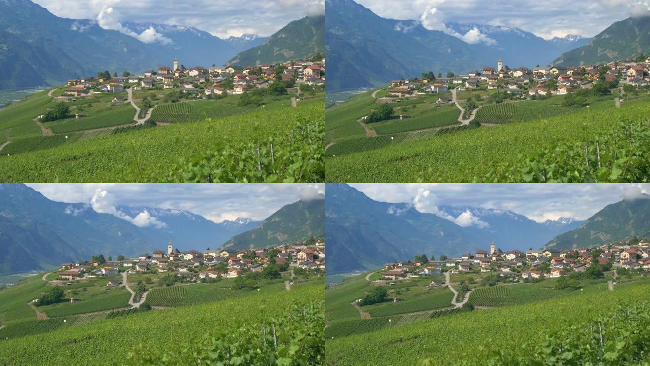 航拍:夏天的一天，美丽的瑞士阿尔卑斯山下安静的高山村庄。