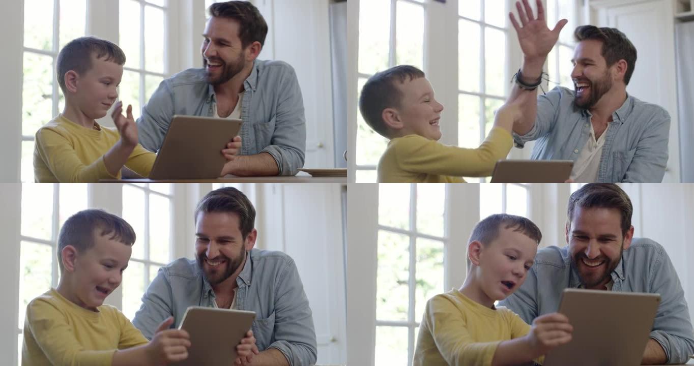 一个小男孩在给父亲击掌时使用数字平板电脑的4k视频片段