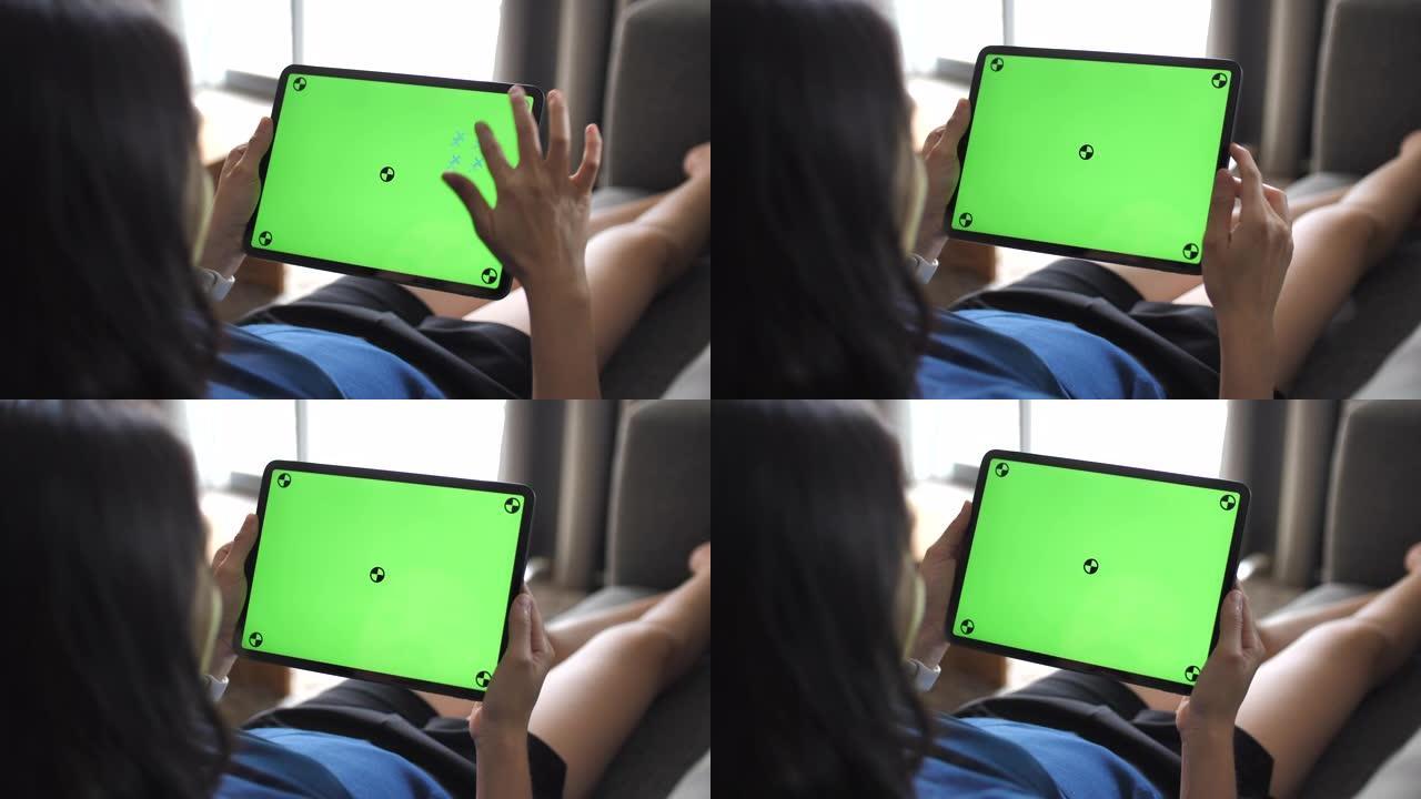 绿屏平板电脑周末时光躺在沙发上女性