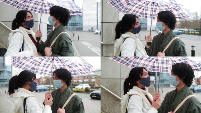 夫妻共用一把雨伞雨天下大雨共享