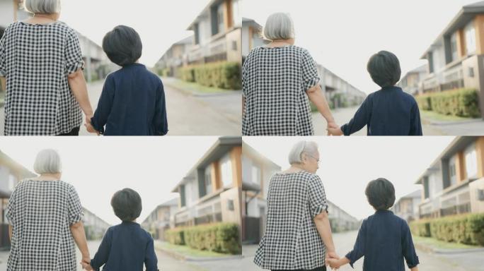 奶奶和孙子在村子里散步。