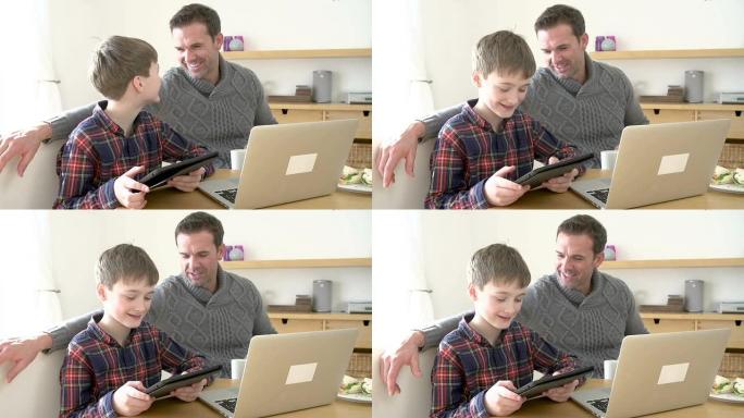父亲在家里使用笔记本电脑，儿子在家里使用数字平板电脑