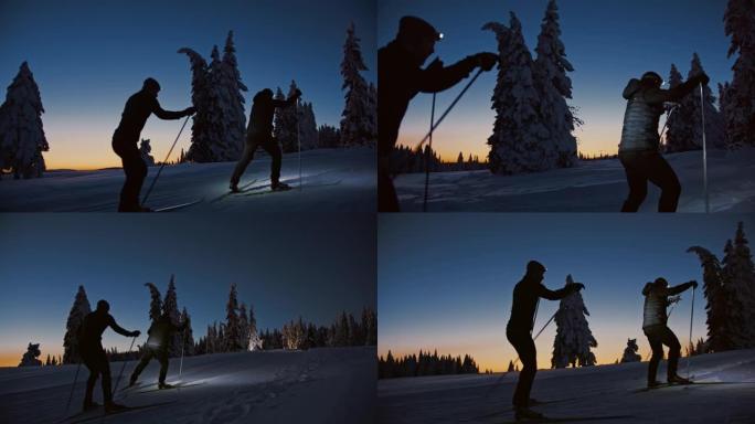 SLO MO两个越野滑雪者在晚上用大灯在云杉树之间滑雪