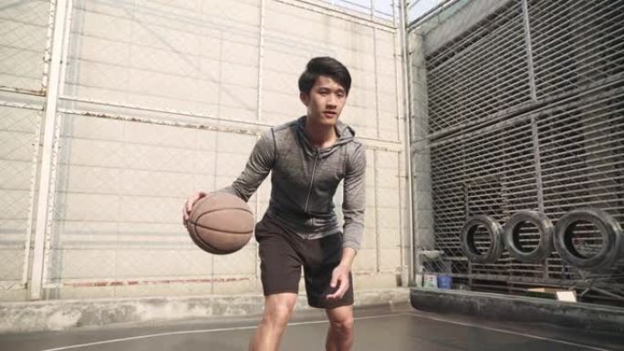 年轻的亚洲篮球运动员在户外练习
