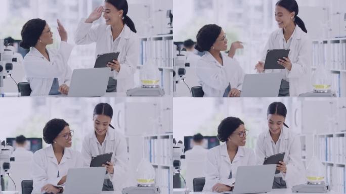 两名科学家在实验室使用数字平板电脑时击掌。快乐的女医生在做出科学发现后庆祝一项成就。先进实验室的成功