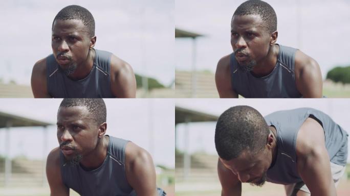 4k视频片段，一个英俊的年轻人在田径练习中蹲在初学者的位置上