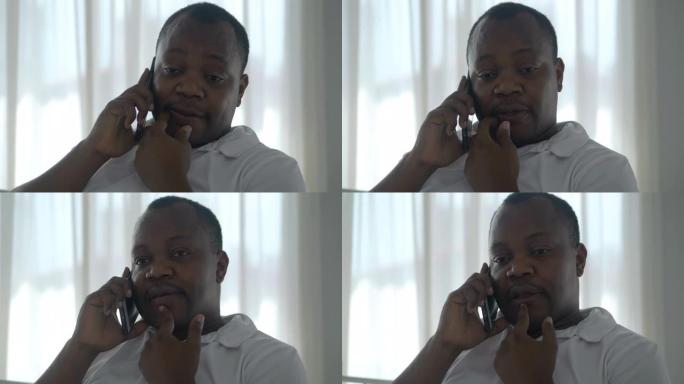 由于冠状病毒或家庭新型冠状病毒肺炎的爆发，工厂关闭时，非洲黑人年轻人聊天并试图通过智能手机找到工作。