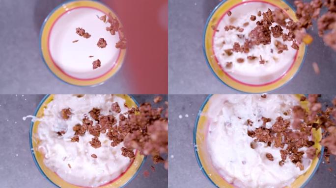 慢动作，特写: 在牛奶碗中飞溅的格兰诺拉麦片的俯视图
