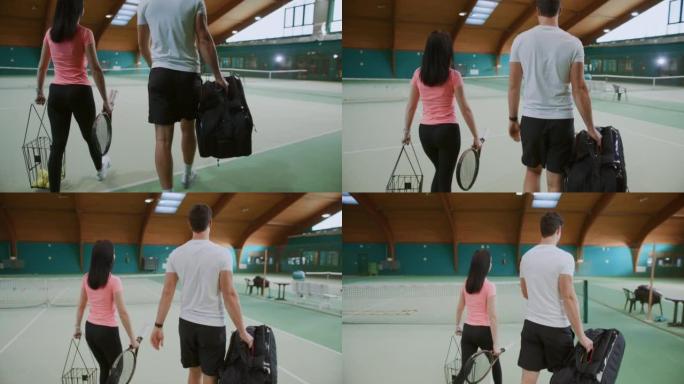 年轻的男教练和带网球设备的妇女走进室内网球场