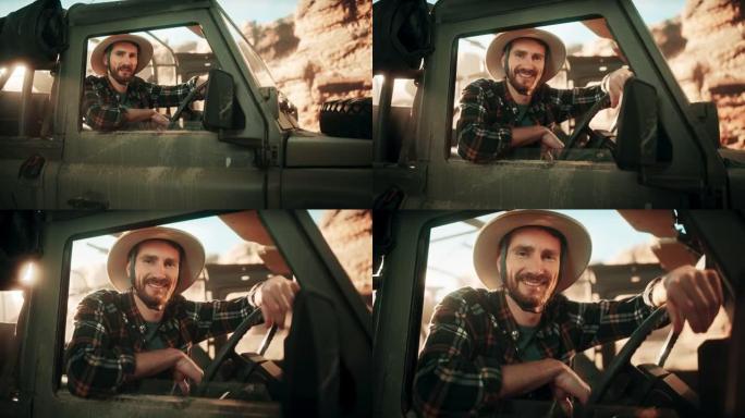 沙漠之旅: 英俊的男性探险家的肖像，从汽车司机的窗户向外望去，微笑着。冒险家乘坐他的越野越野车穿越峡