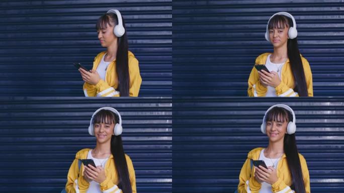 美丽的年轻女子用手机在黑暗的背景下用脖子上的无线耳机发送短信。利用无线技术上网或浏览社交媒体
