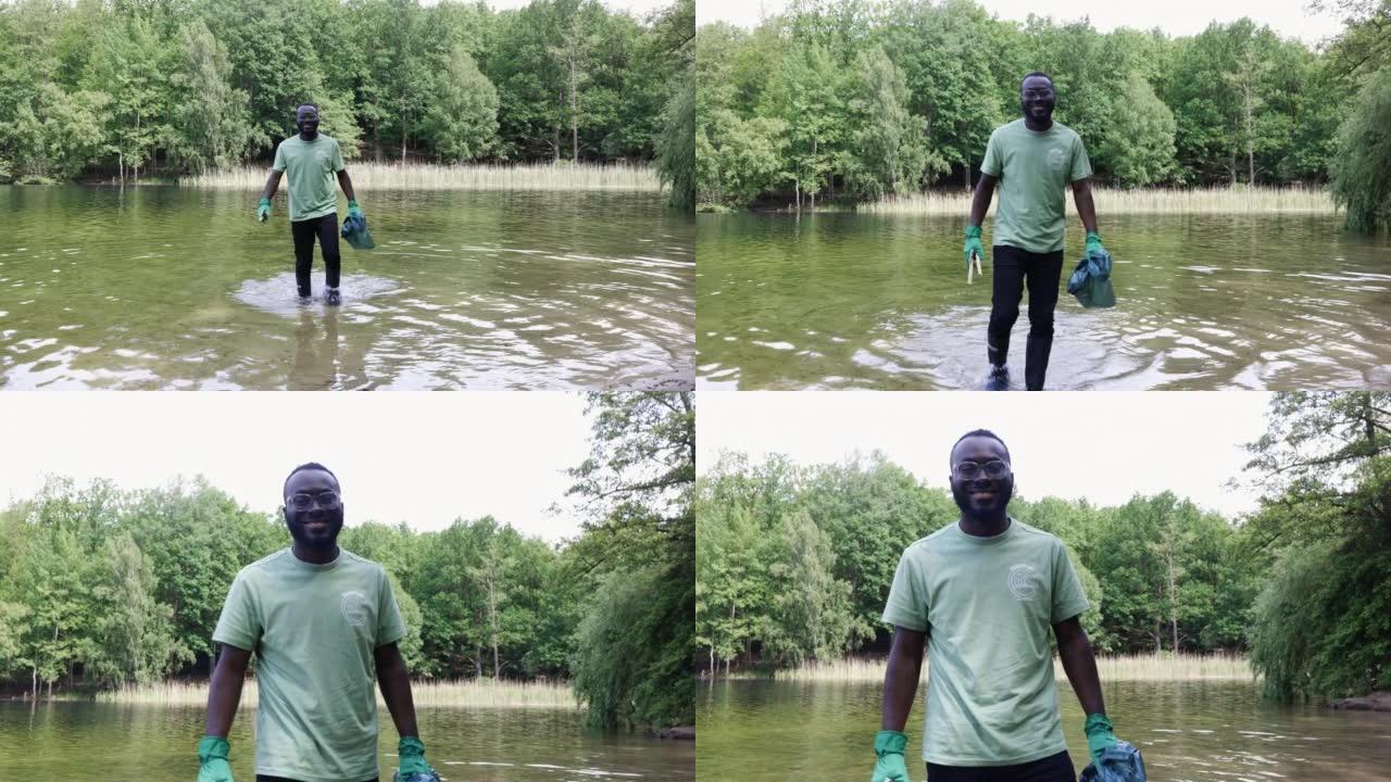 非洲男子志愿者在森林里用垃圾袋清理池塘