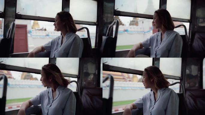美女在公共汽车上旅行时欣赏美景