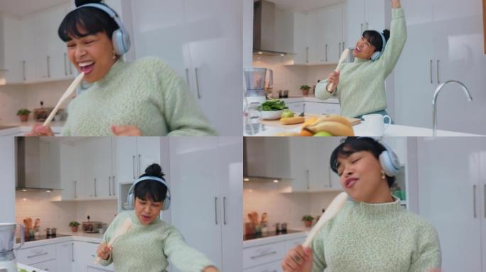 做饭，唱歌和戴着耳机的女人在厨房里听音乐跳舞，放松和快乐。沙拉、健康和食物，年轻女孩在家跳舞，享受自