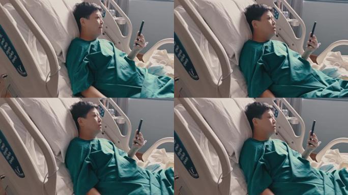 一名亚裔华人女病人躺在医院病房的病床上，正在进行视频通话
