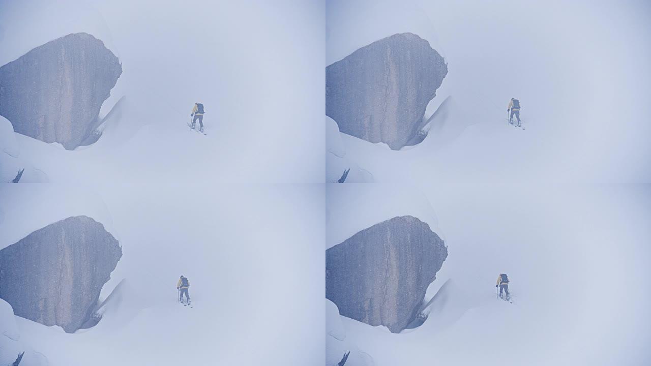 爬上被雪覆盖的山外国人爬雪山登山运动冬季