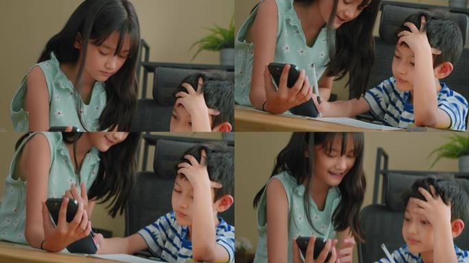 可爱的亚洲姐姐正在帮助弟弟做作业