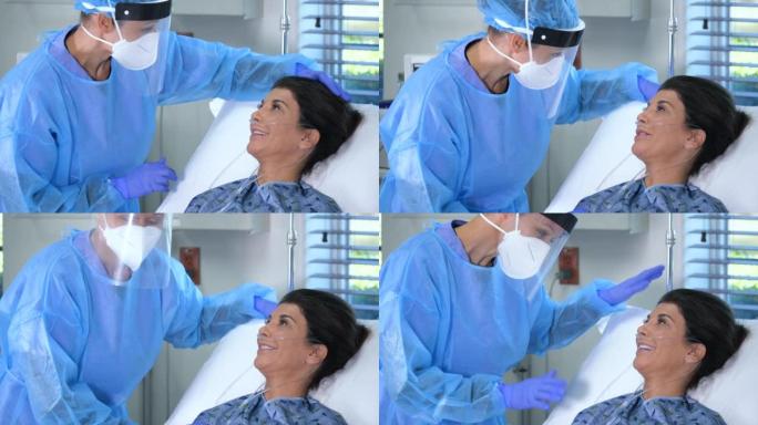PPE中的护士为病床上的病人提供氧气