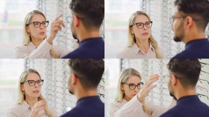 女人检查男人买眼镜的视线。专业的女性验光师与男性顾客交谈，通过在商店进行眼科检查来测试他的视力并为新