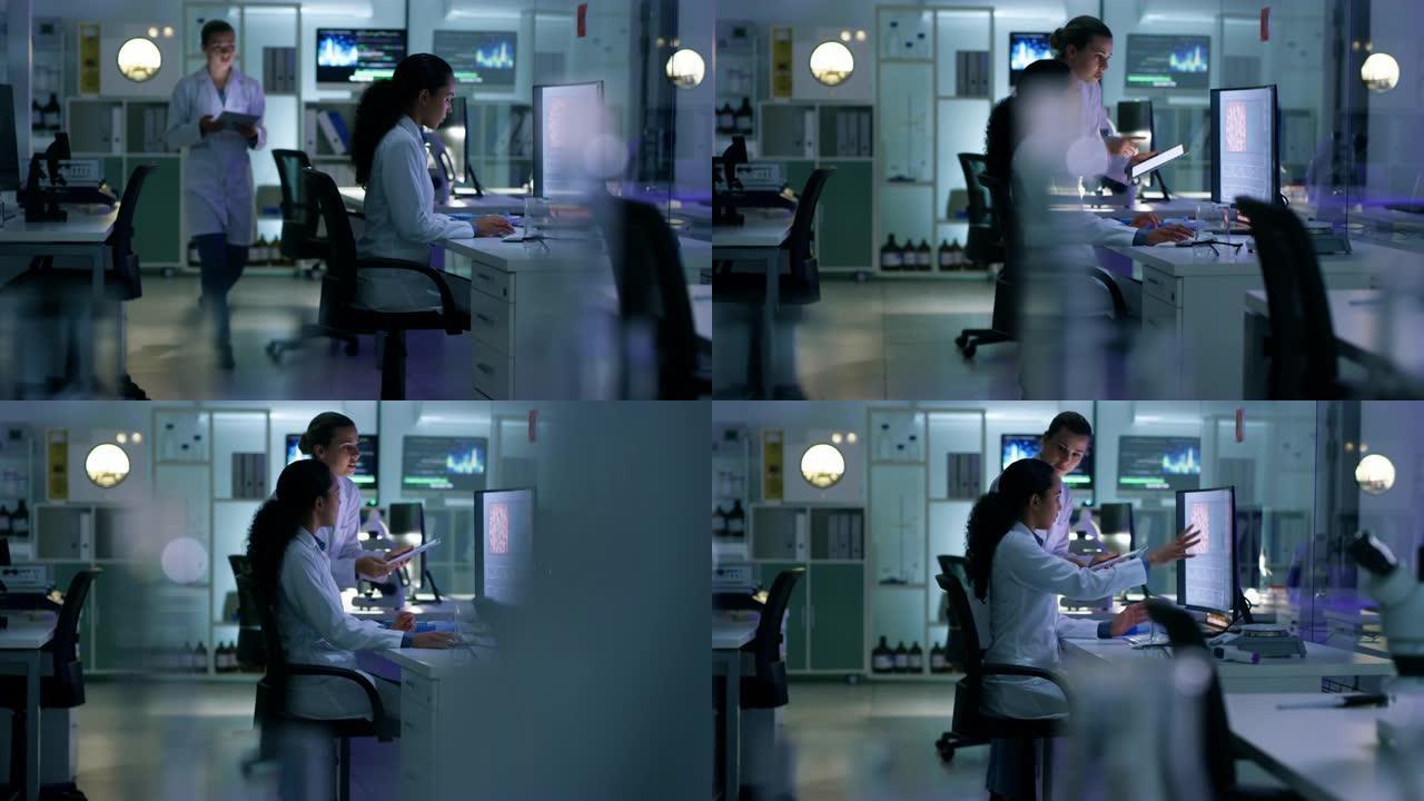 两位科学家在实验室的计算机和数字平板电脑上共同工作的4k视频片段