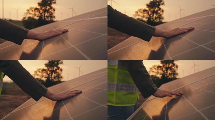 人的手放在能产生能量的太阳能电池板上