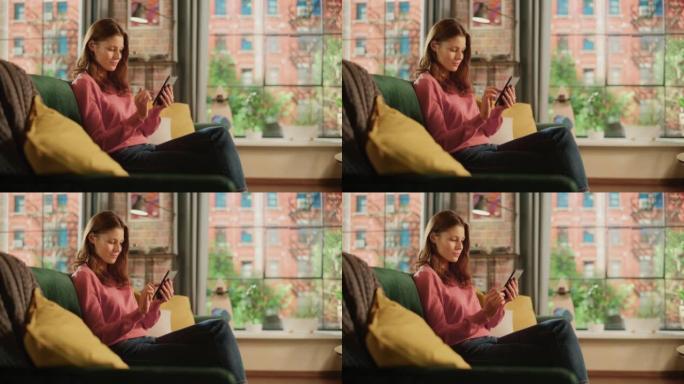 年轻漂亮的女性坐在客厅的沙发上，放松和使用智能手机。创意女孩检查社交媒体，与朋友聊天，浏览互联网。从