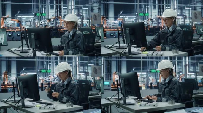 汽车厂办公室: 自信的女总工程师戴着安全帽在台式电脑上工作的肖像。自动化机器人手臂装配线制造高科技电