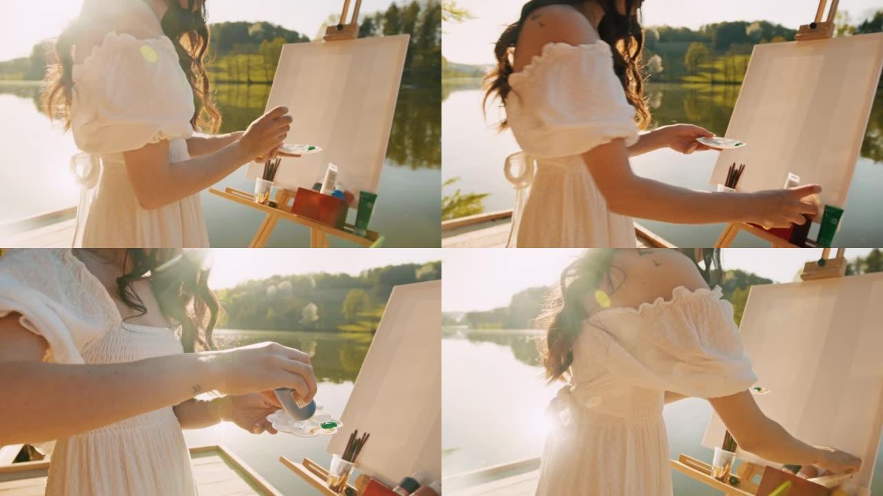 女艺术家站在湖上的码头上时，将颜料管挤到调色板上