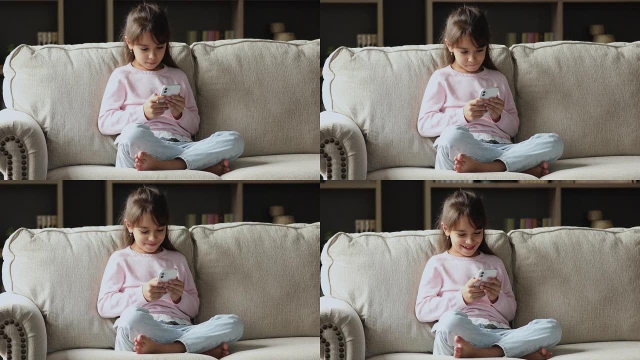 快乐的智能手机用户小女孩浏览互联网，观看媒体内容