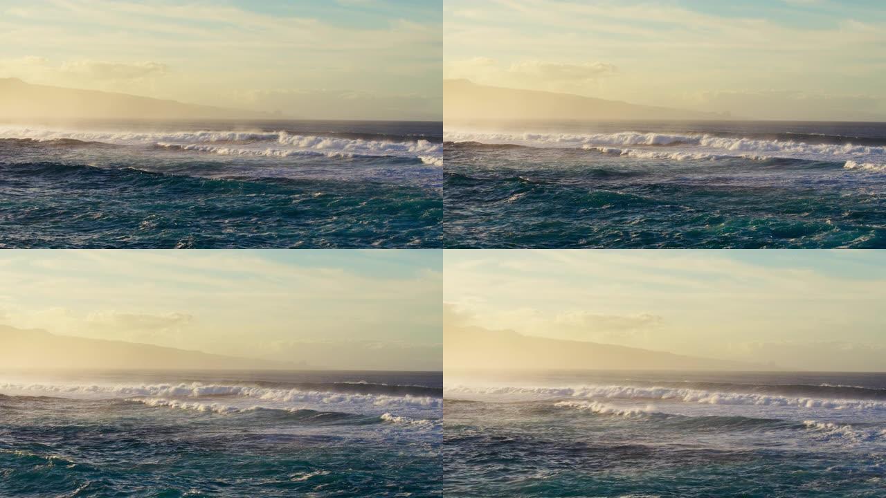 日落时海浪撞击的鸟瞰图