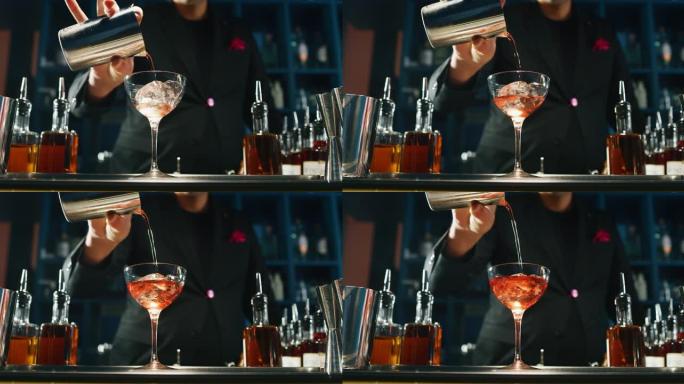 专业调酒师正在酒吧或迪斯科俱乐部为顾客准备含冰块的酒精鸡尾酒。
