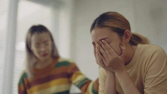 亚洲妇女坐在椅子上，她在治疗师办公室分享自己的抑郁症。
