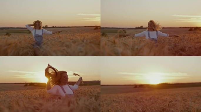 无忧无虑的女人在麦田上奔跑时拿着小麦和草帽