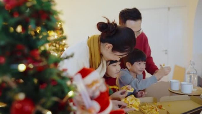 快乐的亚洲家庭和他们的孩子在圣诞节用手摇视频通话。