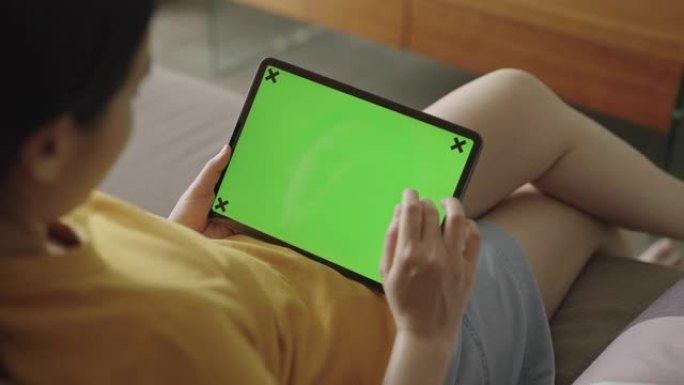 使用绿屏数字平板电脑的女人