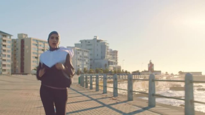 健身，穆斯林妇女和在开普敦的sea point跑步锻炼，有氧运动或健康训练。伊斯兰女跑步者在南非的海