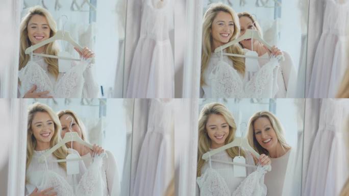 母亲和成年女儿在新娘店里一起选择婚纱 -- 慢动作拍摄