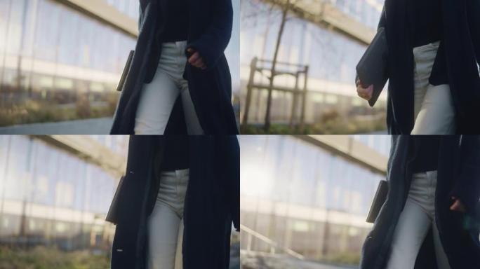 市里携带笔记本电脑的女商人