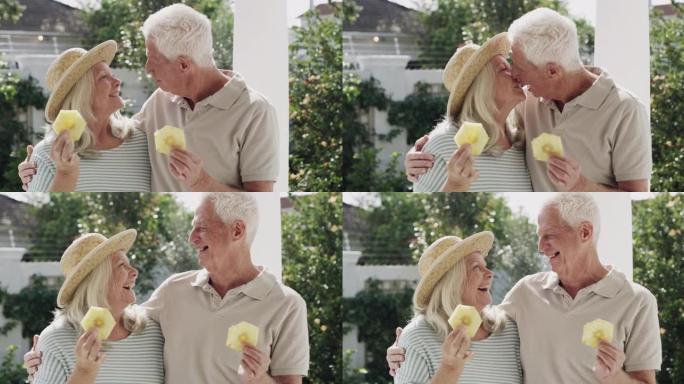4k视频片段，一对高级夫妇站在外面吃了一片菠萝