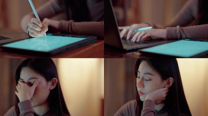 昏昏欲睡的亚洲女性半夜坐在家里的办公桌前，在笔记本电脑和数字平板电脑上看书。