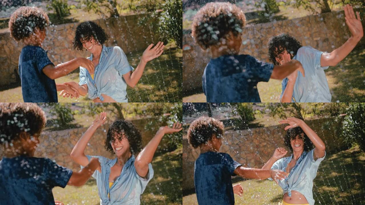 母亲和男孩泼水和玩花园洒水器