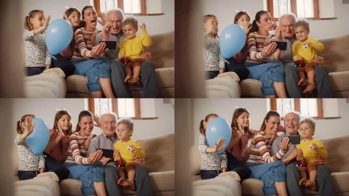 快乐的小家庭在智能手机上进行视频通话，坐在客厅的沙发上挥舞着。通过互联网和技术与远亲建立联系的三代家
