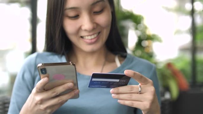 亚洲妇女正在使用智能手机在线购物