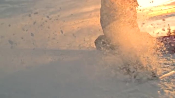 超级SLO MO滑雪者在日落时沿着斜坡雕刻